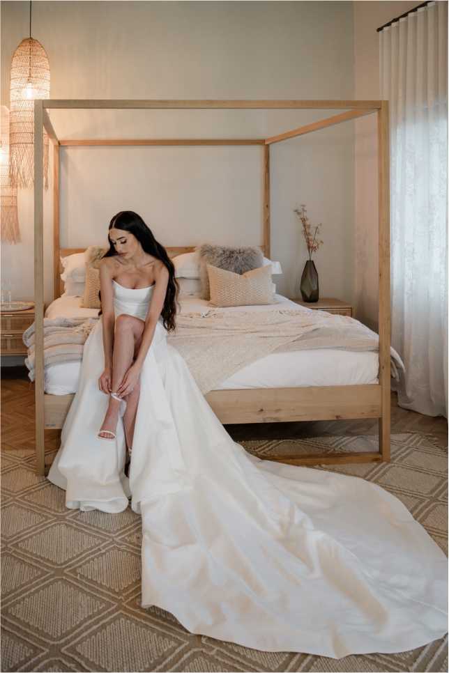 Luxury-Bridal-Suite-Accommodation A bride preparing in the sun-drenched suite of this all inclusive wedding venue and destination wedding venue. On-site bridal suite accommodation at Whispering Thorns bushveld glass wedding venue