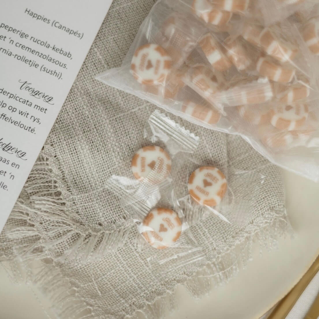 Luxury-Wedding-Favours-Personalised-Sweets Personalised sweets and monogrammed macarons served as wedding favours at a luxury venue.